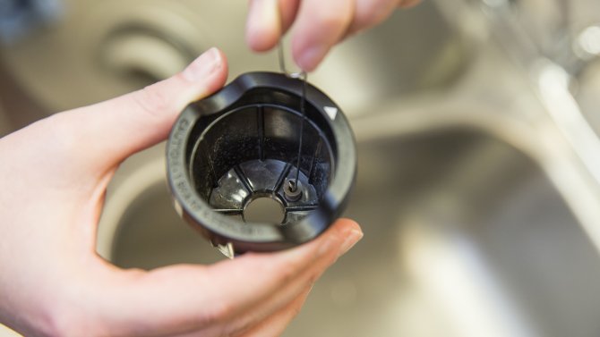 Cleaning the exit needle on a Keurig K-cup holder